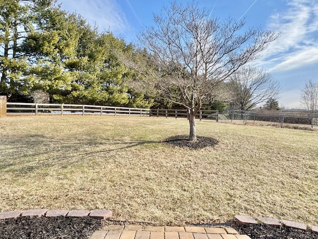 view of yard featuring a rural view and fence