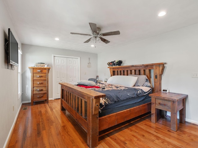 bedroom with baseboards, wood finished floors, and recessed lighting