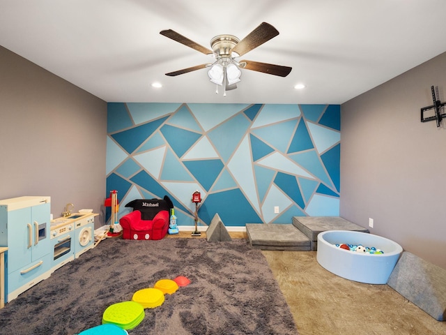 recreation room featuring wallpapered walls, ceiling fan, an accent wall, carpet, and recessed lighting