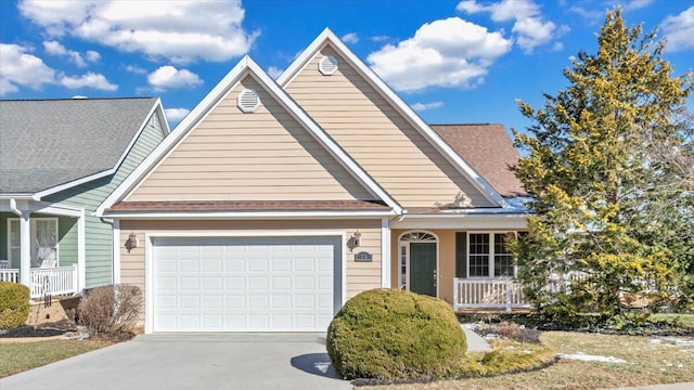 traditional-style house with driveway, an attached garage, and a porch