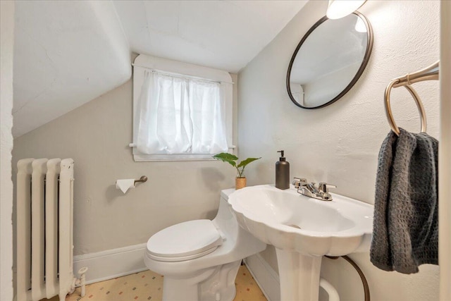 half bath with lofted ceiling, radiator heating unit, toilet, and baseboards