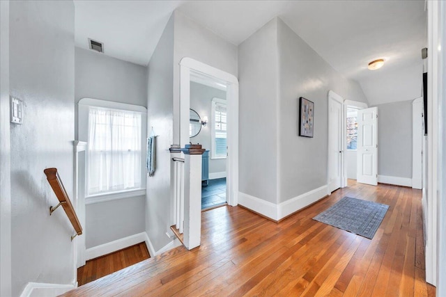 entryway featuring baseboards, visible vents, and hardwood / wood-style floors