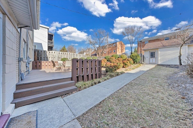 view of yard with fence and a deck