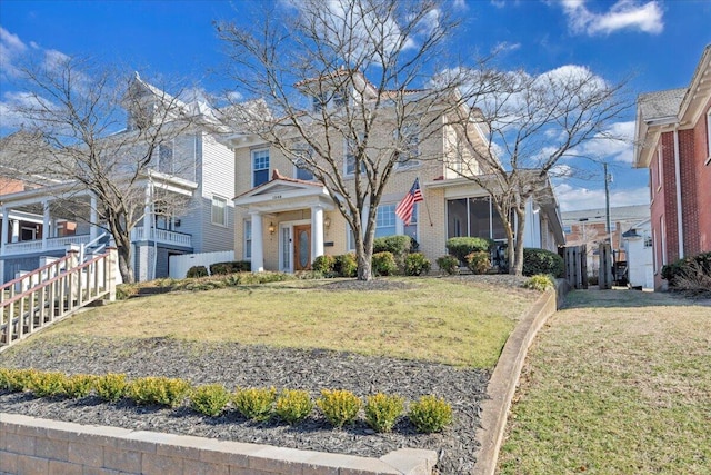 view of front of home featuring a residential view, brick siding, and a front lawn