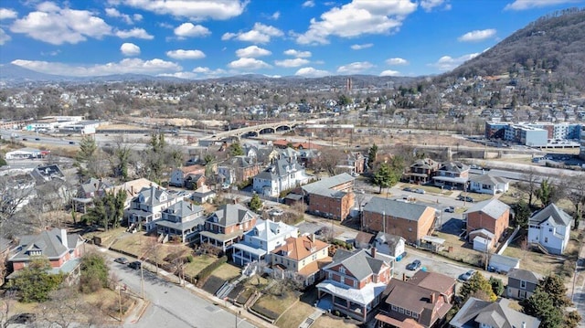 drone / aerial view featuring a residential view and a mountain view