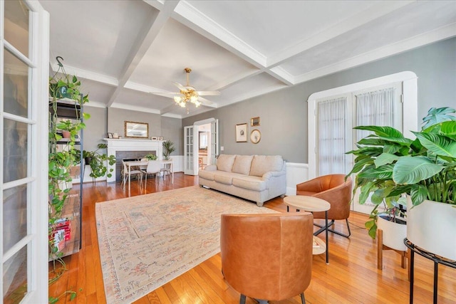 living room featuring a fireplace, coffered ceiling, wood-type flooring, and beam ceiling