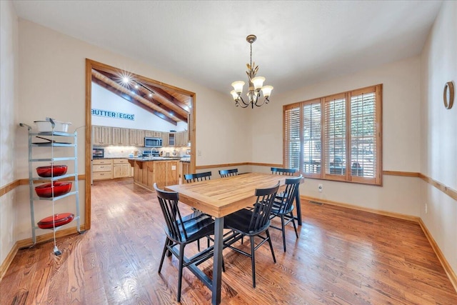 181 Borderline Rd NW, Willis, VA 24380 - dining area featuring visible vents, baseboards, lofted ceiling, a notable chandelier, and light wood-type flooring