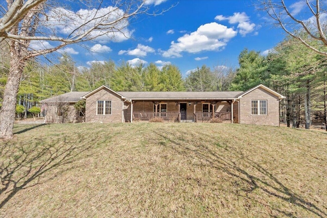 ranch-style home with a front lawn, brick siding, and covered porch