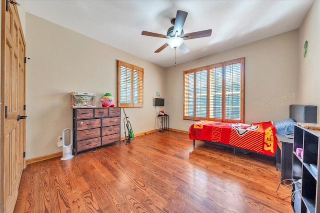181 Borderline Rd NW, Willis, VA 24380 - bedroom featuring multiple windows, a ceiling fan, baseboards, and wood finished floors