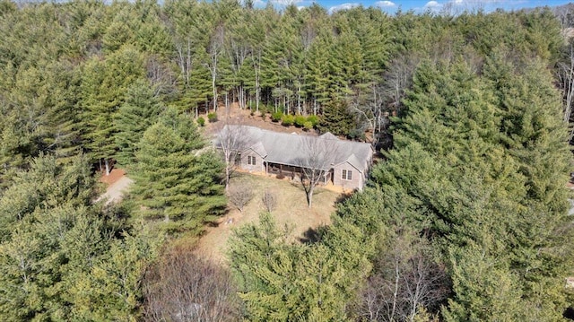 birds eye view of property featuring a wooded view