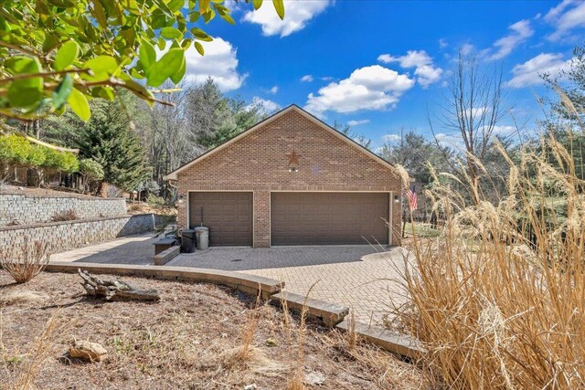 181 Borderline Rd NW, Willis, VA 24380 - exterior space with a garage, brick siding, an outdoor structure, and driveway