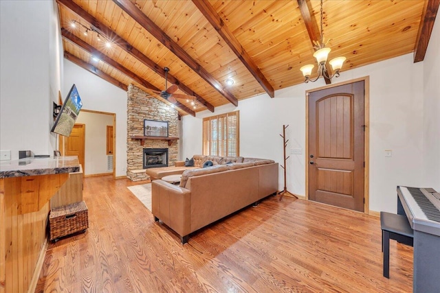 181 Borderline Rd NW, Willis, VA 24380 - living room with beam ceiling, a stone fireplace, wooden ceiling, light wood-style floors, and an inviting chandelier