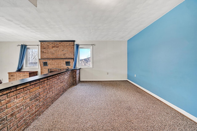 unfurnished room featuring baseboards, a healthy amount of sunlight, and carpet flooring