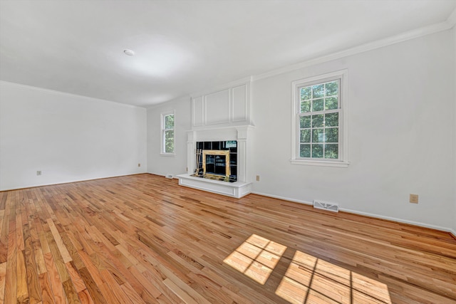 4937 Greenlee Rd SW, Roanoke, VA 24018 - unfurnished living room featuring plenty of natural light, light wood-type flooring, a fireplace, and ornamental molding