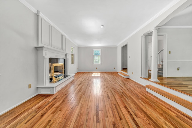 4937 Greenlee Rd SW, Roanoke, VA 24018 - unfurnished living room with ornamental molding, light wood-style floors, a tiled fireplace, and stairs