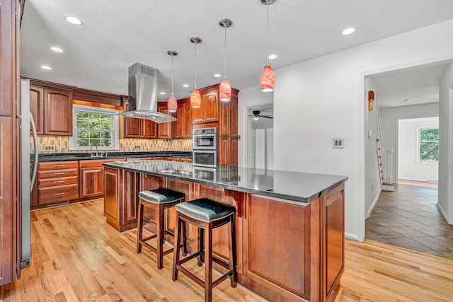 4937 Greenlee Rd SW, Roanoke, VA 24018 - kitchen featuring island exhaust hood, stainless steel appliances, a center island, plenty of natural light, and recessed lighting
