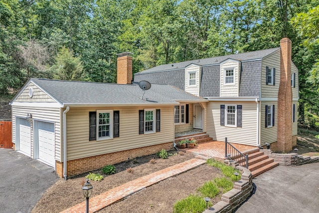 4937 Greenlee Rd SW, Roanoke, VA 24018 - colonial inspired home featuring a chimney, roof with shingles, a garage, and asphalt driveway