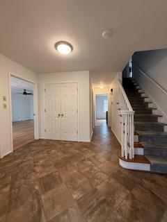spare room with wood finished floors, baseboards, and ceiling fan