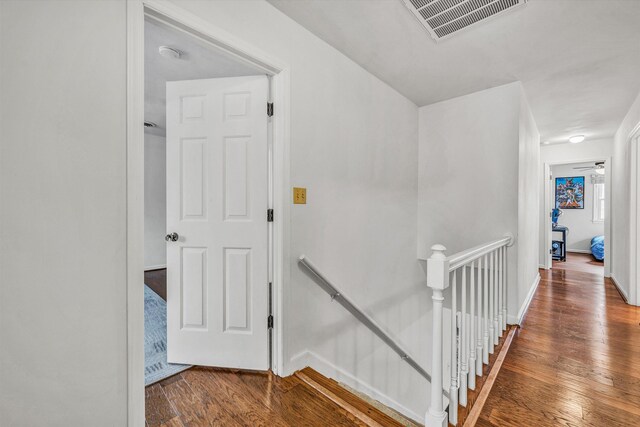empty room featuring ceiling fan, baseboards, wood finished floors, and visible vents
