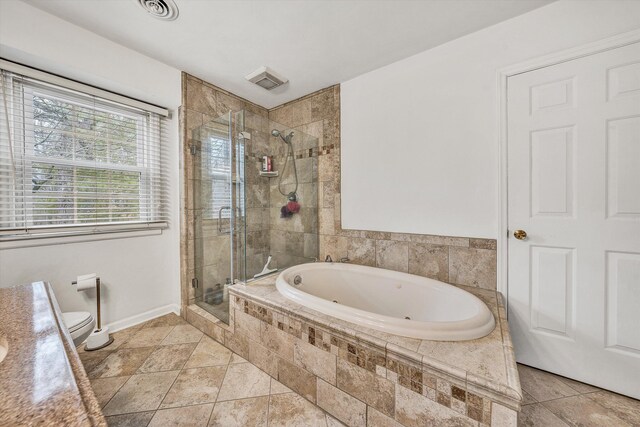 ensuite bathroom with a shower stall, a ceiling fan, ensuite bathroom, vanity, and visible vents