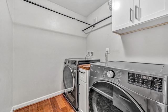 4937 Greenlee Rd SW, Roanoke, VA 24018 - washroom with cabinet space, separate washer and dryer, and wood finished floors