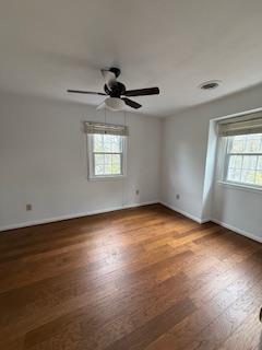 unfurnished bedroom with recessed lighting, wood finished floors, and baseboards