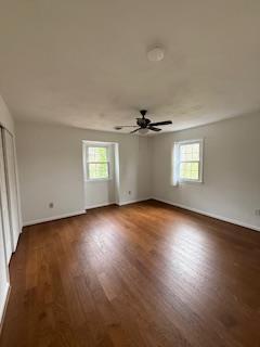 unfurnished bedroom featuring wood finished floors and baseboards