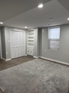 finished below grade area with baseboards, recessed lighting, and wood finished floors