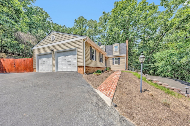 4937 Greenlee Rd SW, Roanoke, VA 24018 - view of front of house featuring driveway, an attached garage, and a chimney
