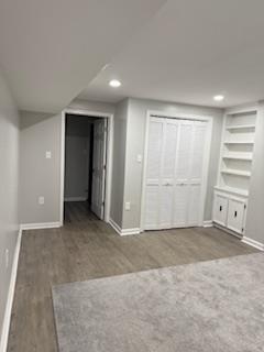 full bathroom with a tile shower, wood finished floors, and vanity