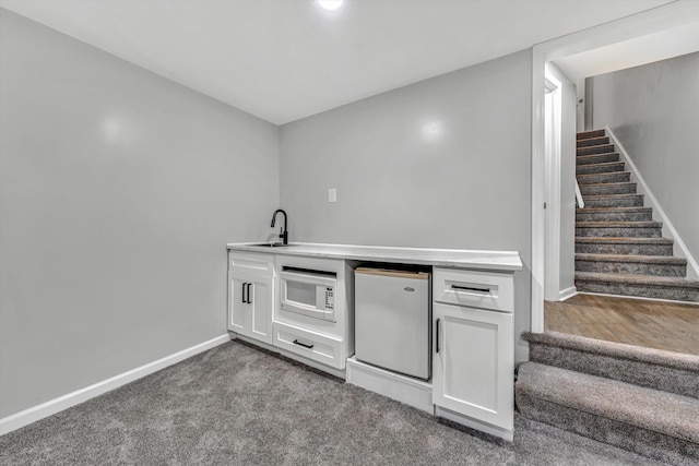 4937 Greenlee Rd SW, Roanoke, VA 24018 - bar area featuring fridge, stairs, white microwave, and carpet