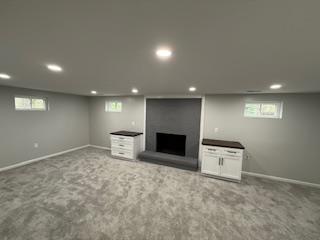 basement with recessed lighting, carpet flooring, and a fireplace