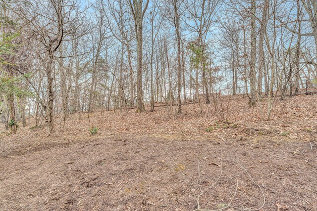 back of property with a gambrel roof, a fenced backyard, roof with shingles, and a patio