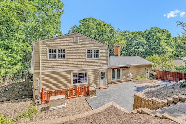 4937 Greenlee Rd SW, Roanoke, VA 24018 - back of property featuring a patio area, a fenced backyard, a chimney, and french doors