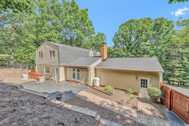 4937 Greenlee Rd SW, Roanoke, VA 24018 - rear view of property with a patio, roof with shingles, a chimney, and french doors