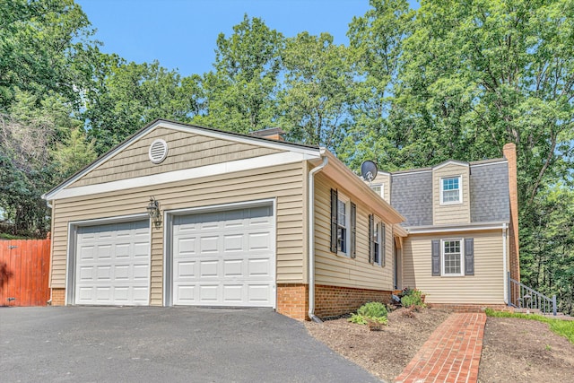 4937 Greenlee Rd SW, Roanoke, VA 24018 - view of front of house featuring driveway, a chimney, and roof with shingles