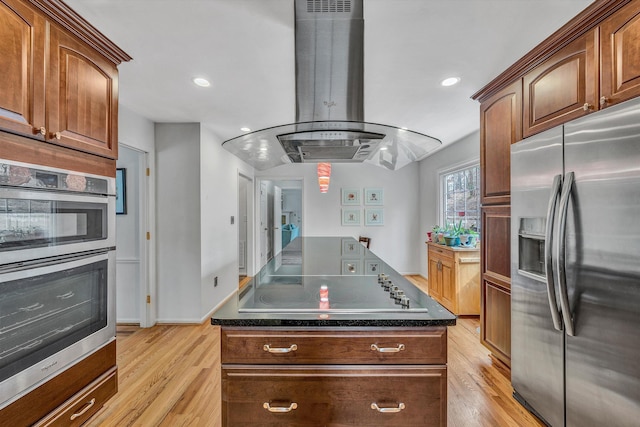 kitchen with recessed lighting, light wood-type flooring, dark countertops, island range hood, and appliances with stainless steel finishes