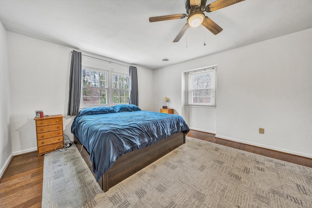 bedroom with wood finished floors, a ceiling fan, and baseboards