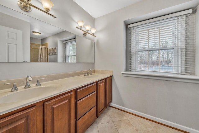 bathroom featuring a shower with curtain, a sink, tile patterned floors, and baseboards