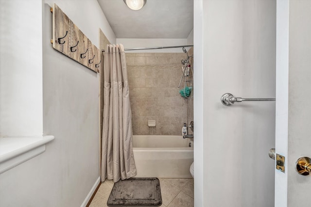 full bath featuring toilet, shower / tub combo with curtain, and tile patterned floors