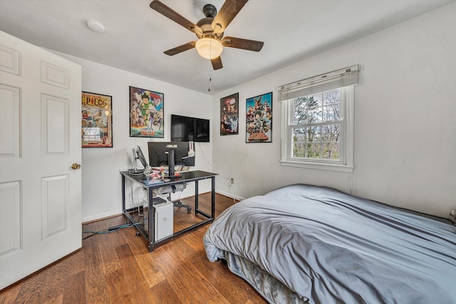 bedroom with baseboards, wood finished floors, and a ceiling fan