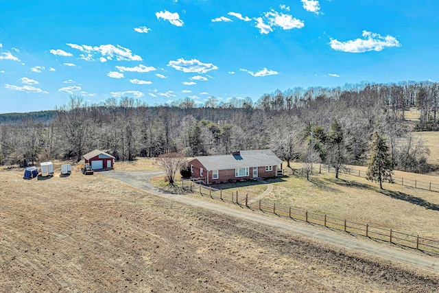 birds eye view of property with a view of trees and a rural view