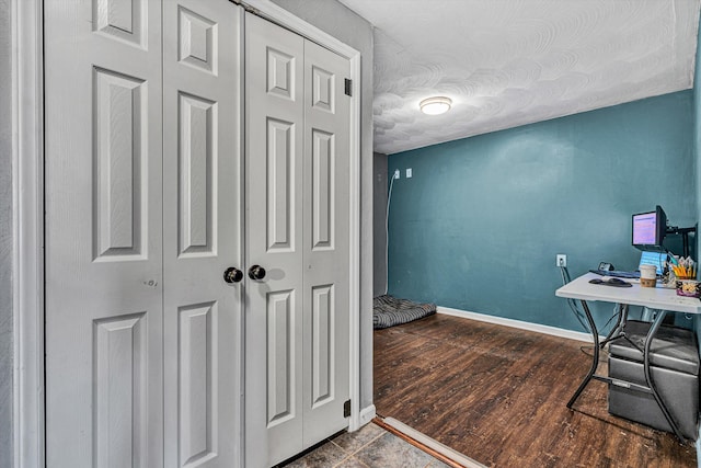 office space featuring a textured ceiling, wood finished floors, and baseboards