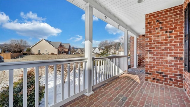 balcony featuring covered porch and a residential view