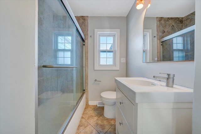 full bathroom featuring baseboards, toilet, enclosed tub / shower combo, tile patterned flooring, and vanity