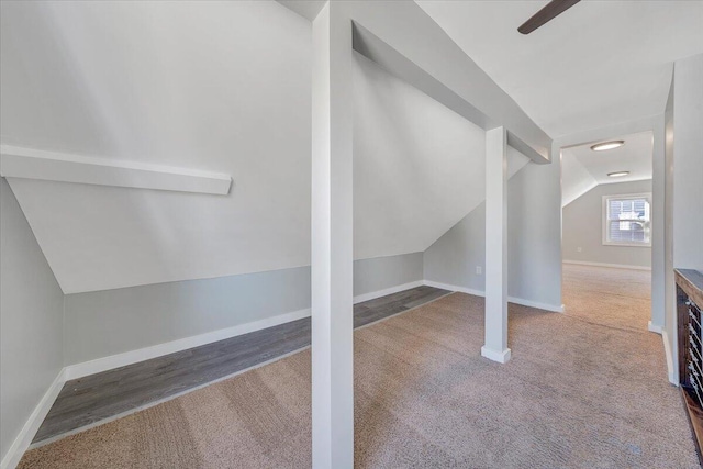 bonus room with vaulted ceiling, carpet, and baseboards