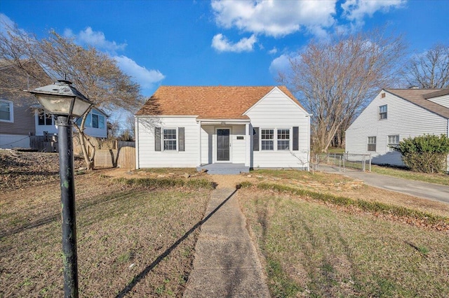 bungalow-style house featuring fence