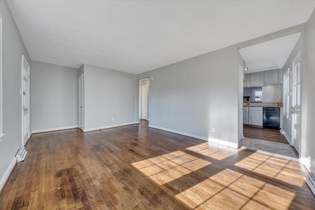 unfurnished living room with dark wood-style floors and baseboards