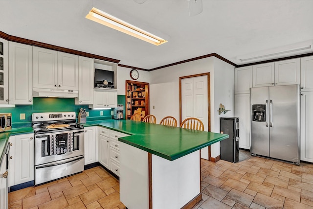 kitchen featuring dark countertops, appliances with stainless steel finishes, glass insert cabinets, white cabinets, and under cabinet range hood