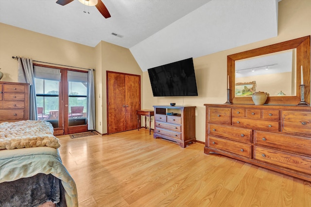 bedroom with lofted ceiling, visible vents, light wood-style floors, access to outside, and baseboards